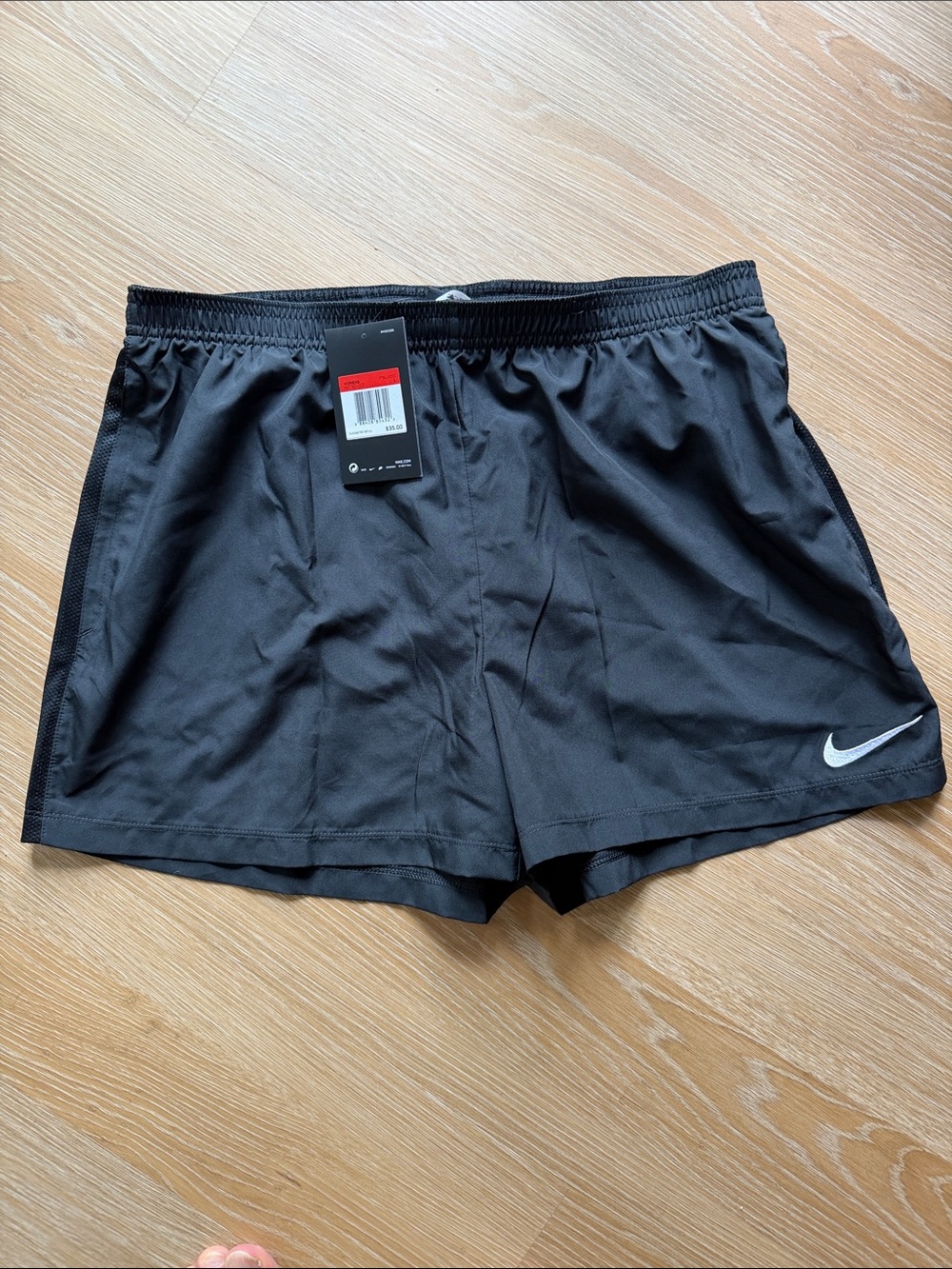 Nike Women’s Black Athletic Shorts with White Swoosh with zipper pockets
